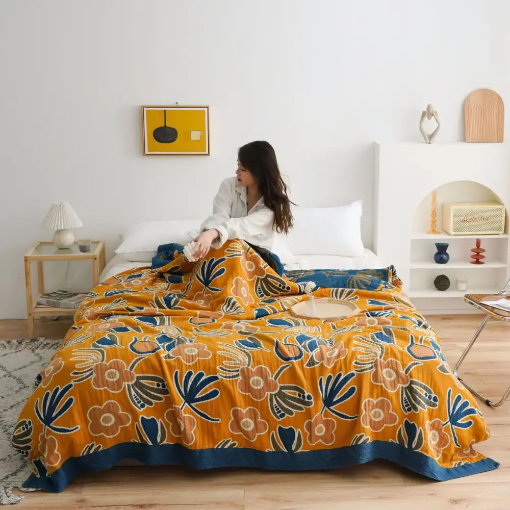 Vibrant orange floral cotton gauze boho throw blanket with navy accents and plush texture for bedroom or living room decorbites cotton gauze