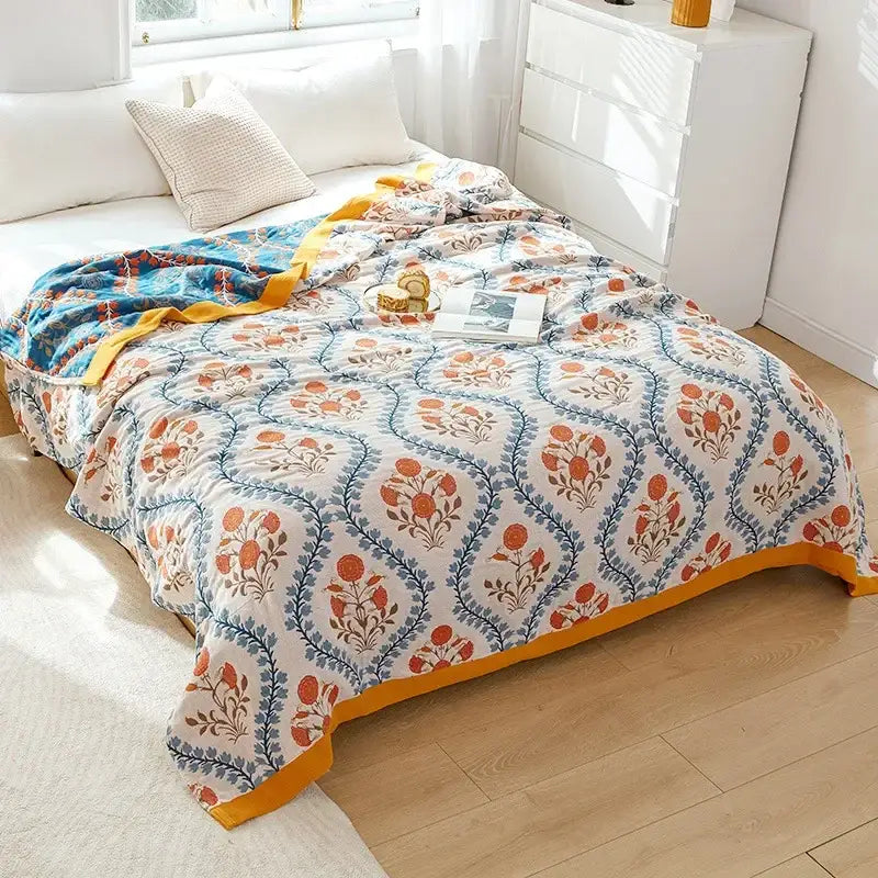 Cozy cream-colored multicolored cotton gauze boho throw blanket with floral pattern and mustard-yellow border for decorbites