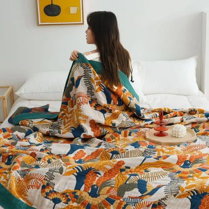 A multicolored decorbites cotton gauze boho throw blanket with vibrant botanical print for bedroom or living room decor
