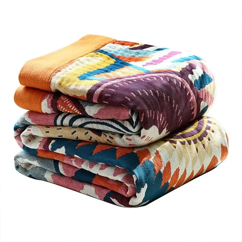 Stack of multicolored cotton gauze boho throw blankets with vibrant geometric patterns for bedroom or living room decorbites cotton gauze