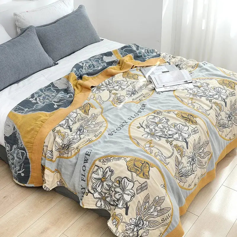 Soft cream-colored decorbites cotton gauze boho throw blanket with gray yellow floral pattern for bedroom or living room decor