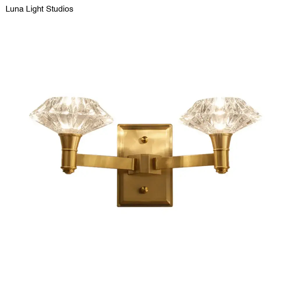 Mussel brass crystal wall mounted lamp with brass finish and two faceted crystal shades for bedroom wall lamp use