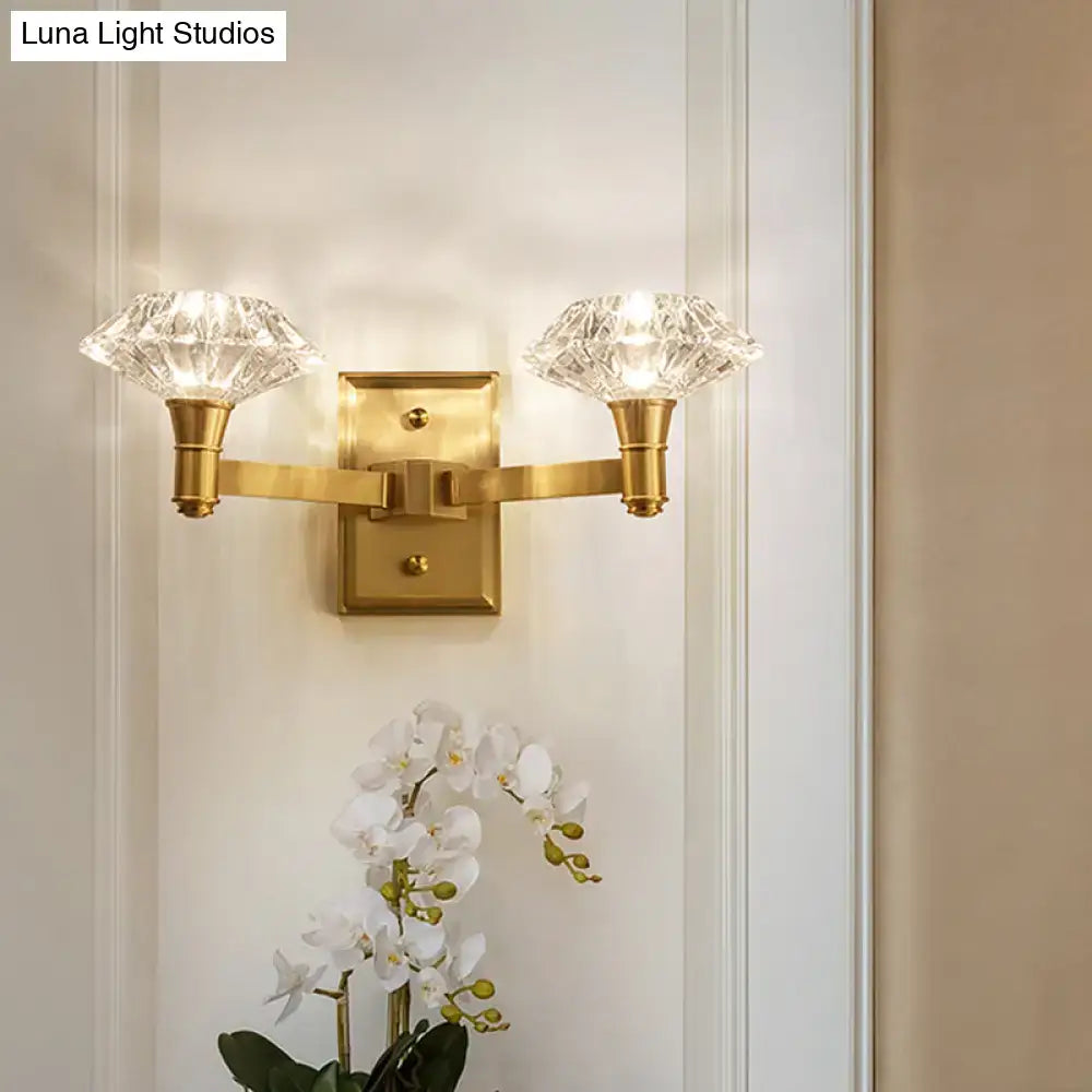 Gold-toned mussel brass wall mounted lamp with two faceted crystal shades for bedroom or doorway wall lamp use