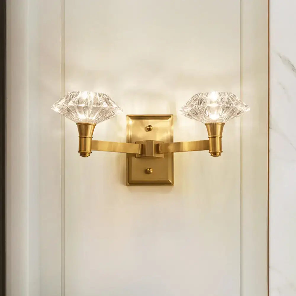 Mussel brass crystal wall mounted lamp with two faceted crystal shades for use as a bedroom wall lamp or doorway wall lamp