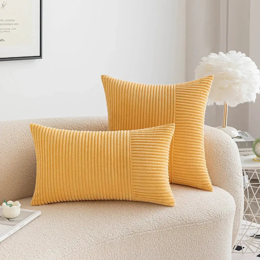 Two mustard yellow decorbites corduroy striped pillow covers with ribbed texture in rectangular and square shapes