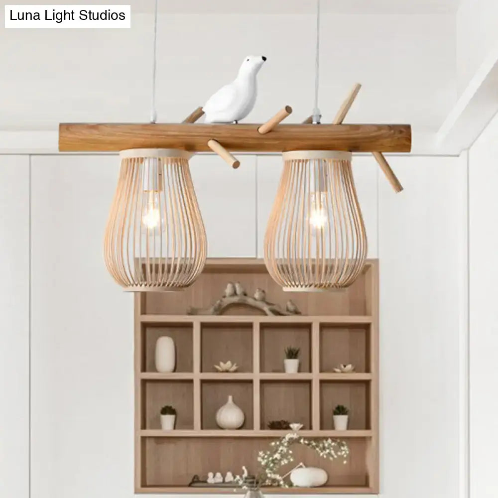 Natural bamboo barrel pendant lights with two woven bamboo shades and a ceramic bird for dining room island lighting