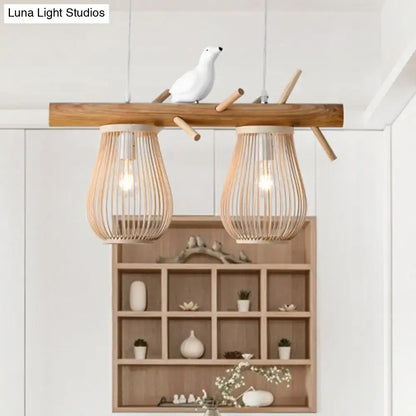 Natural bamboo barrel pendant lights with two woven bamboo shades and a ceramic bird for dining room island lighting