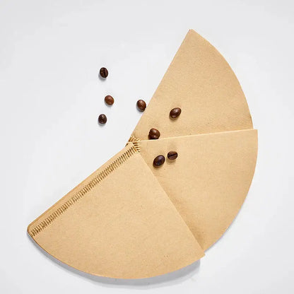 Natural brown cone coffee filter papers with stitched edges and scattered dark roasted coffee beans for decorbites coffee filter use
