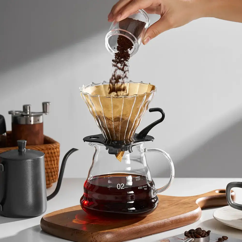 Natural brown cone coffee filter paper with golden fluted glass dripper and black base for decorbites coffee filter use