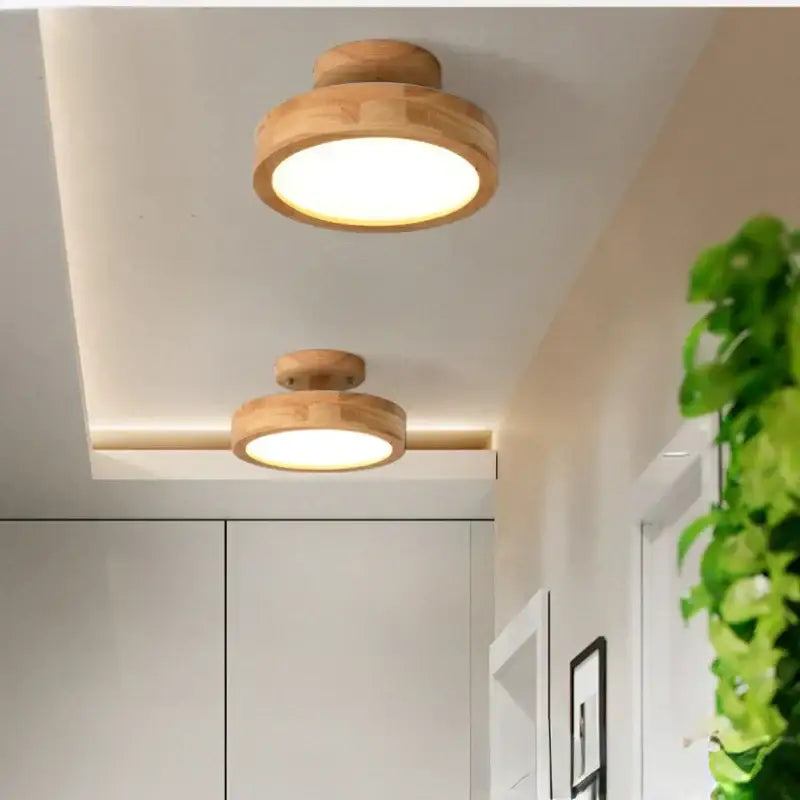 Two circular wood ceiling lamps with warm natural finish and recessed led lighting for living room decorbites circular wood