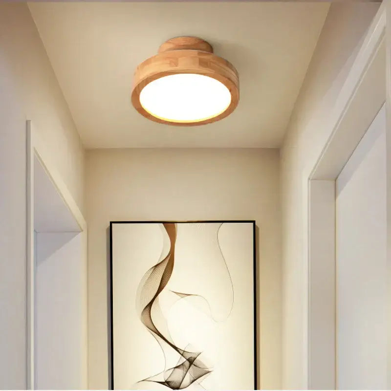 A warm-toned decorbites circular wood ceiling lamp with natural wood finish and smooth rounded edges for living rooms