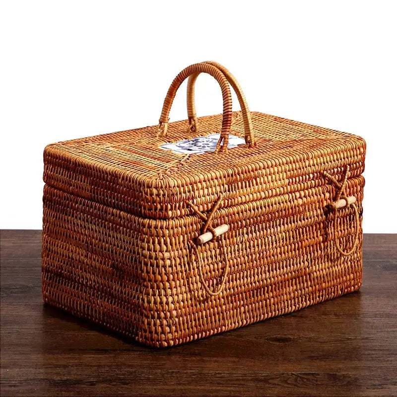 Natural tan handwoven rattan storage box with ceramic lid featuring a woven wicker design and wooden toggle closures