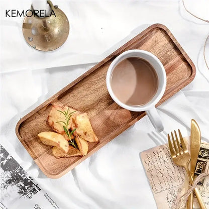 Natural two-tone acacia wood coffee tray with rounded edges holding a white mug and rosemary garnished potato wedges
