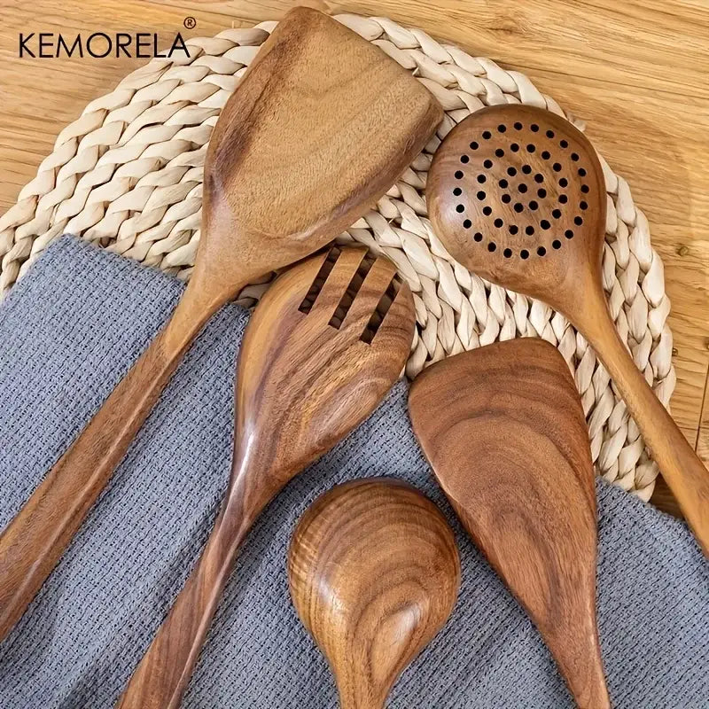 Set of four natural wooden kitchen utensils in rich brown tones from a polished wooden tableware set