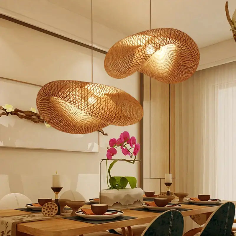 Two warm-toned natural woven bamboo pendant lights by decorbites hang above a dining table as bamboo pendant light decor