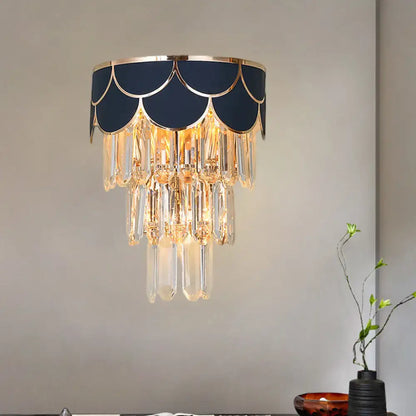 Navy and gold living room wall sconce with scalloped design and rectangle-cut crystal droplets for elegant lighting