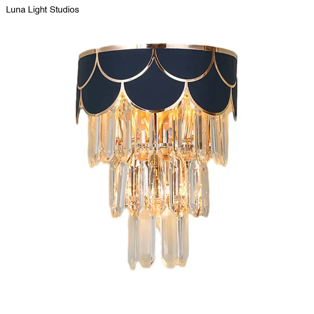 Elegant navy and gold scalloped wall sconce with rectangle-cut crystal prisms for living room lighting