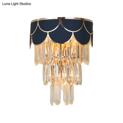 Elegant navy and gold scalloped wall sconce with rectangle-cut crystal prisms for living room lighting