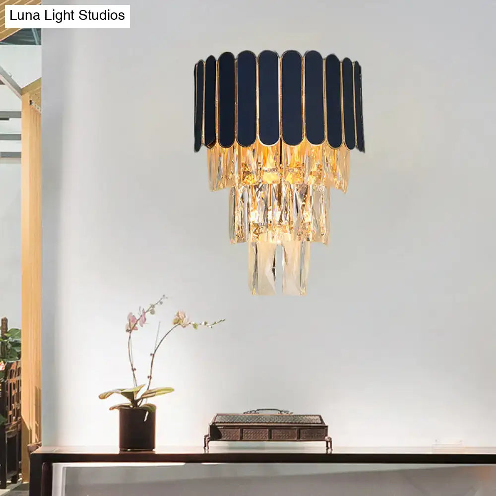 Elegant navy and gold rectangle-cut crystal wall sconce featuring a modern tiered design living room lighting idea