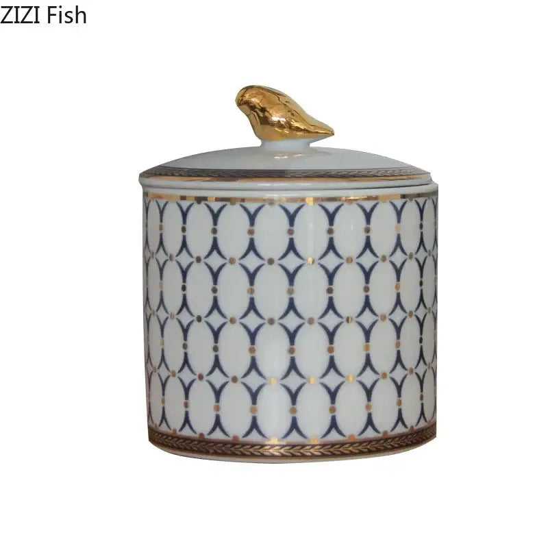 White porcelain storage jar with navy and white geometric pattern and gold plated bird decorbites gold plated topper