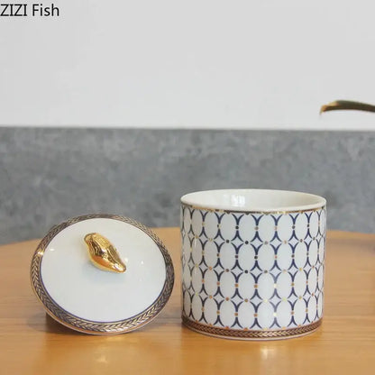 White ceramic storage jar with navy blue geometric pattern and gold plated bird handle for bedroom decorbites decor
