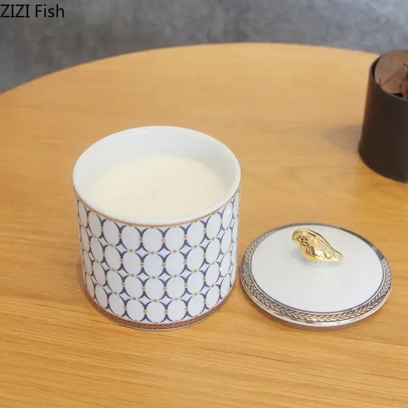 White ceramic storage jar with navy and white geometric pattern and gold plated bird lid decorbites gold plated