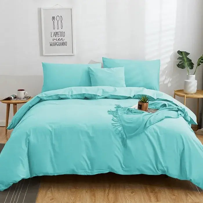 Turquoise solid color decorbites cotton 4pcs bedding set with matching pillows and fringed throw blanket displayed
