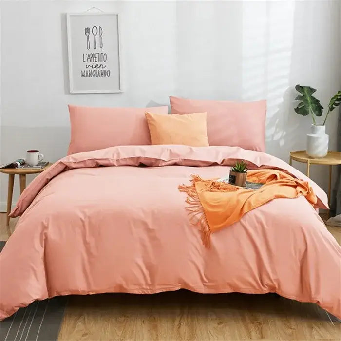 Soft peach-colored cotton bedding set with matching pillows and cozy orange throw from decorbites solid color 4pcs collection