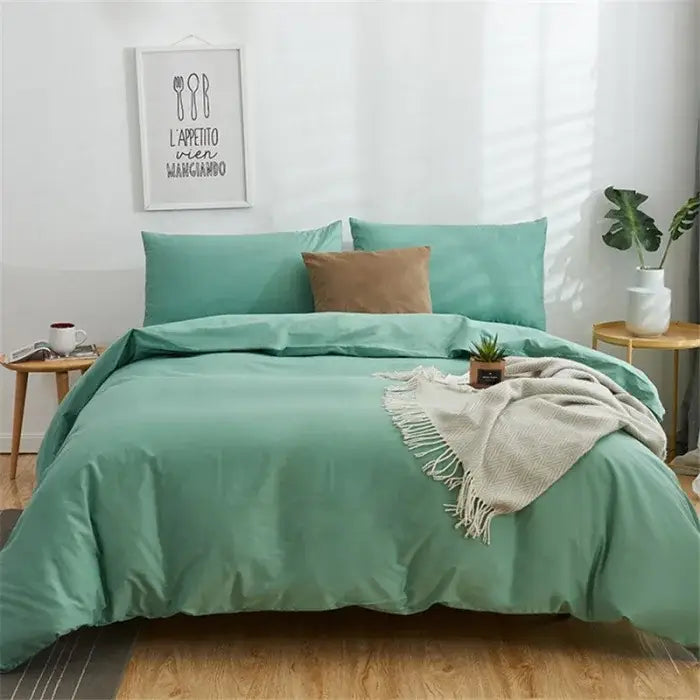 Teal solid color bedding set with decorbites cotton 4pcs featuring a duvet cover, pillows, brown throw pillow, and beige blanket