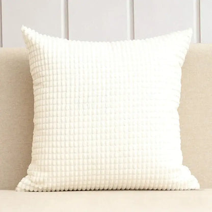 White waffle-textured throw pillow complementing navy and charcoal corduroy corn grain cushion cover decorbites set