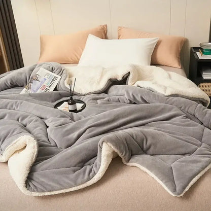 Gray plush throw blanket with soft white fleece lining in a double layer queen sherpa comfort blanket design