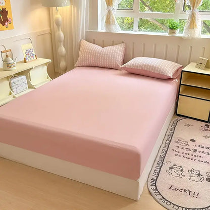 Pink microfiber bed elastic fitted sheet with smooth stretchy fabric snugly covering a double bed mattress