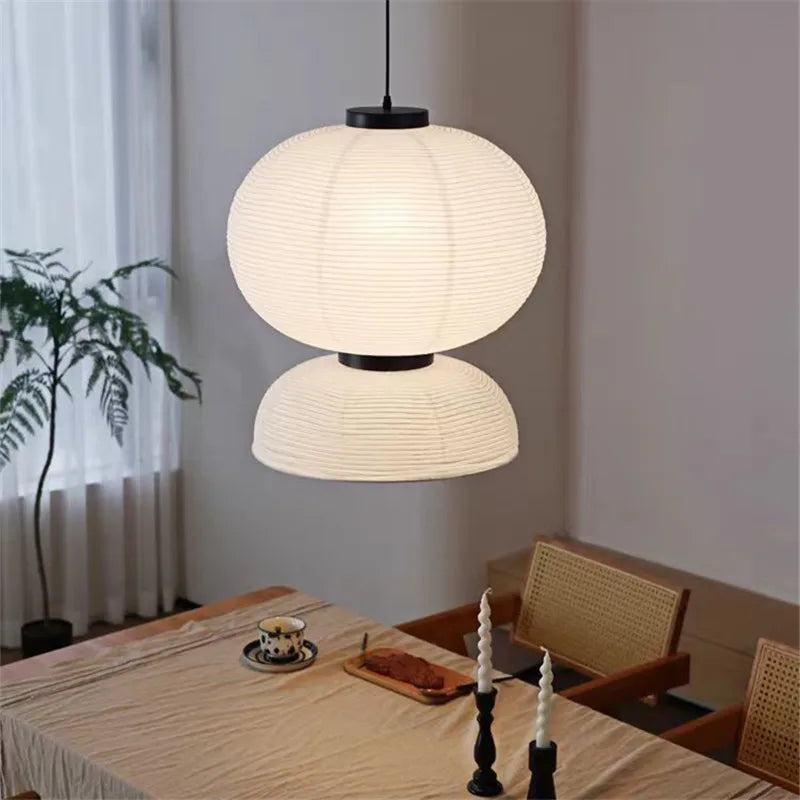 A modern two-tiered white ribbed paper Noguchi pendant light with black accents for dining room shop hanging light