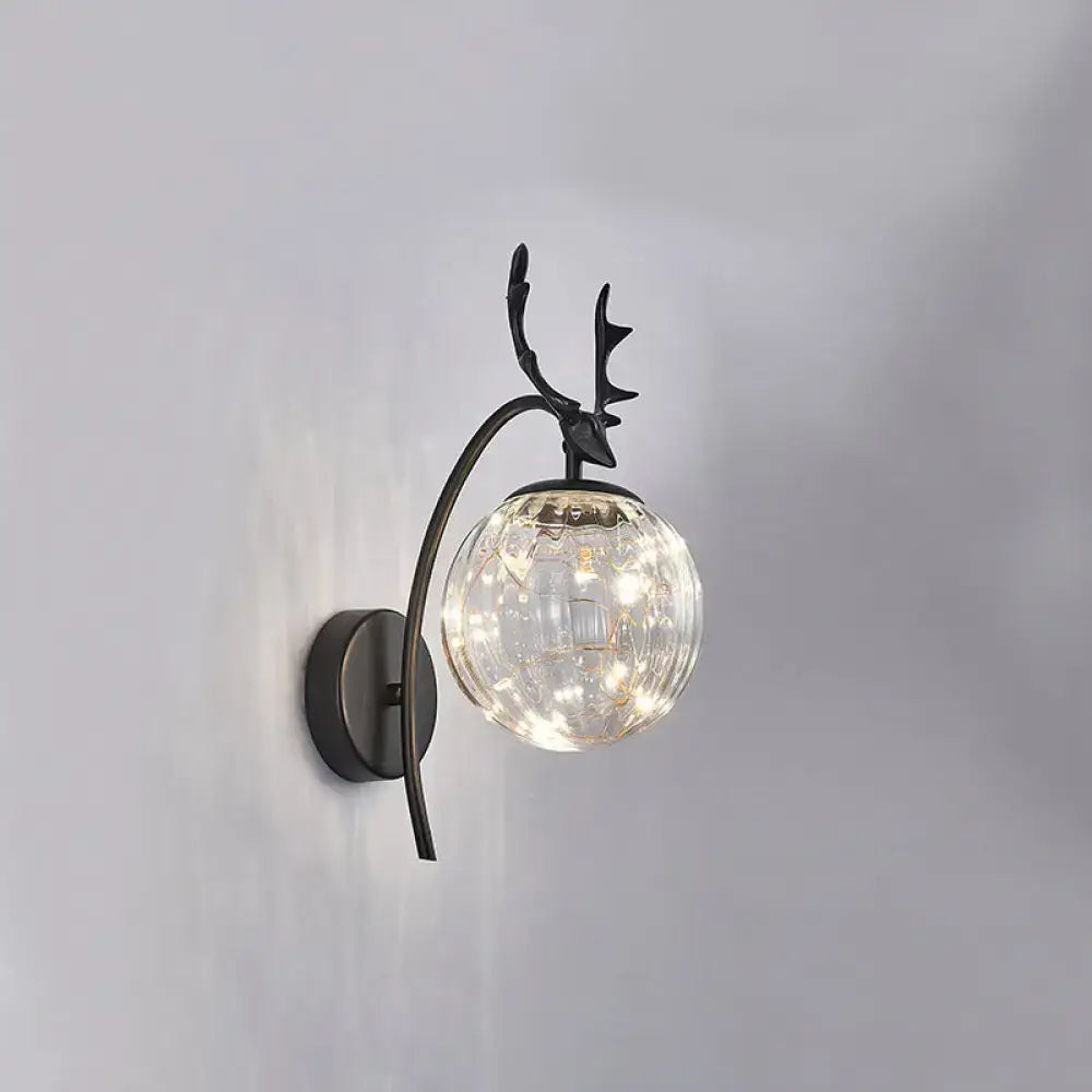 Black metal nordic ball wall mount sconce with antler design and textured clear glass globe housing warm led lights