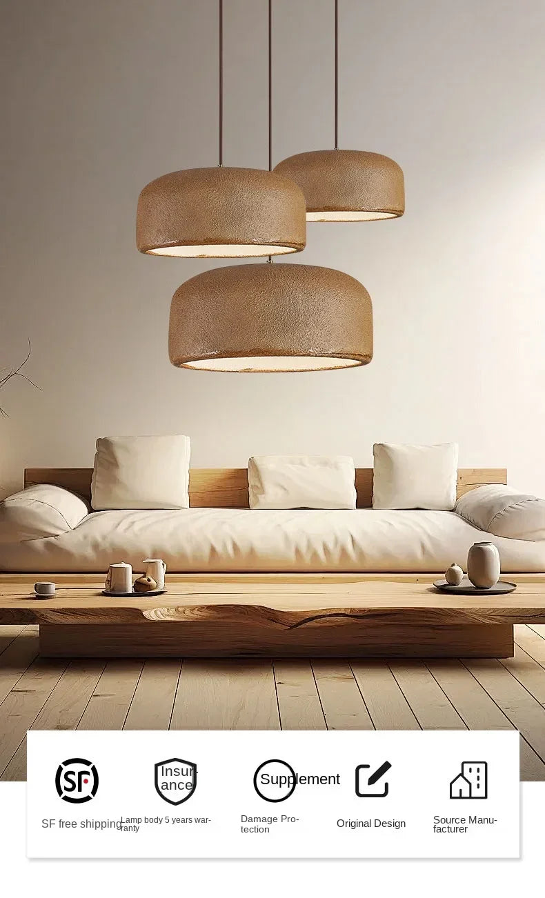 Three warm-toned woven nordic led pendant lamps hang asymmetrically above a sofa for bar or restaurant lighting