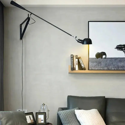 Black articulated wall lamp with adjustable long arm and sleek modern design for bedroom lighting