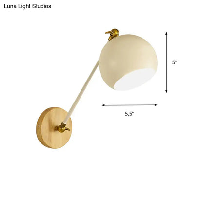 Cream-colored spherical wall light with brass mounting plate and articulated arm featuring e26 e27 bulb socket