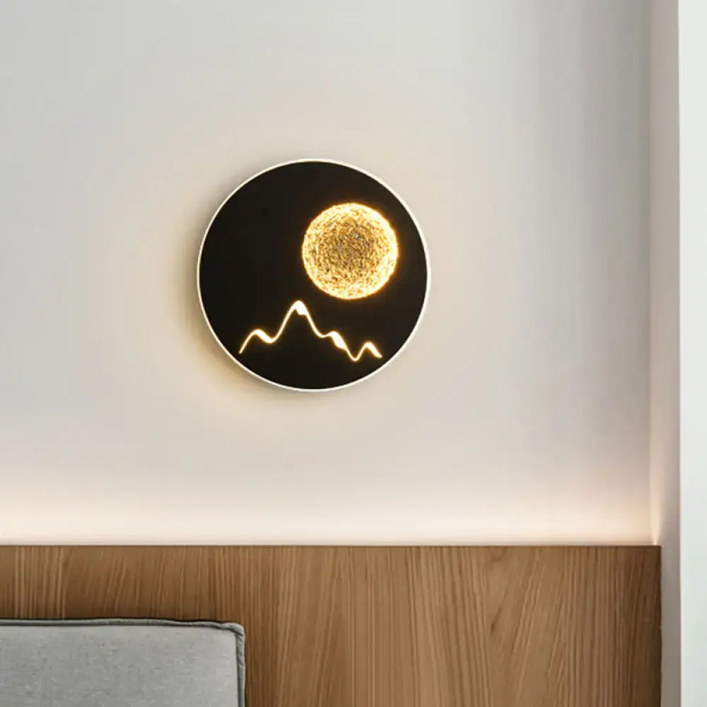 Nordic black white grey circular wall light fixture with illuminated golden sphere and stylized mountain design for bedroom
