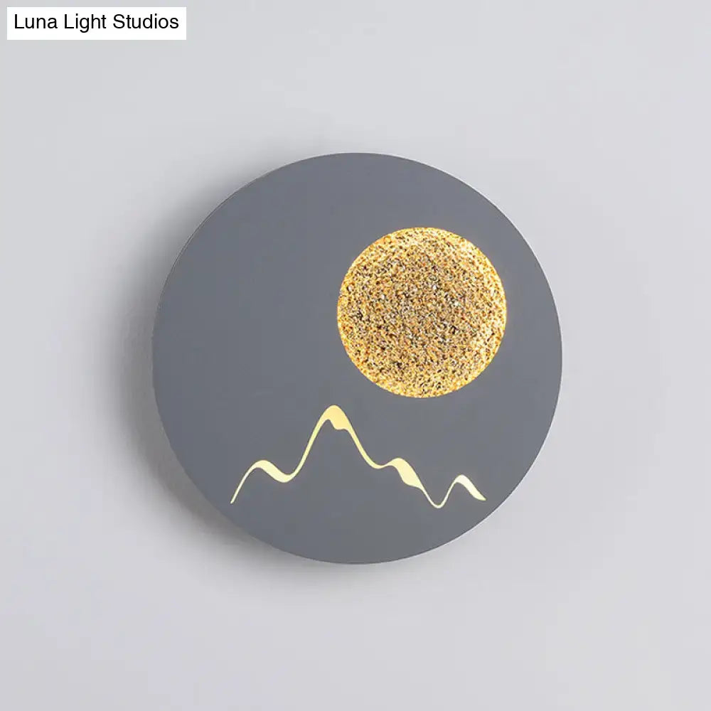 Nordic black white grey wall light featuring a circular matte gray face with gold moon and white mountain silhouettes, fixture height ideal for bedroom