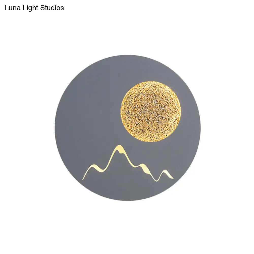 Nordic black white grey mountain wall light fixture with textured gold sun and white mountain silhouette on gray background