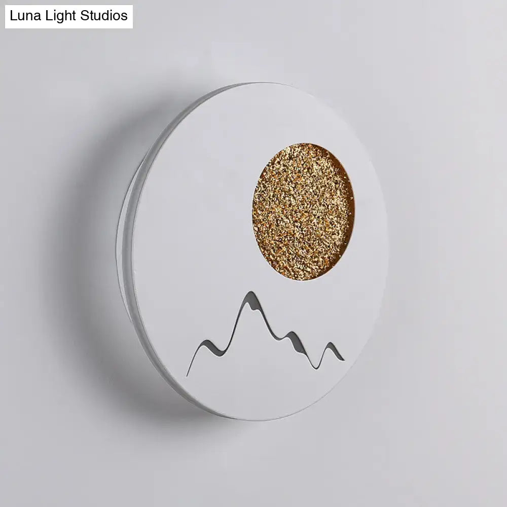 White circular wall light with gold glitter sun and black mountain silhouette in nordic black white grey design fixture height