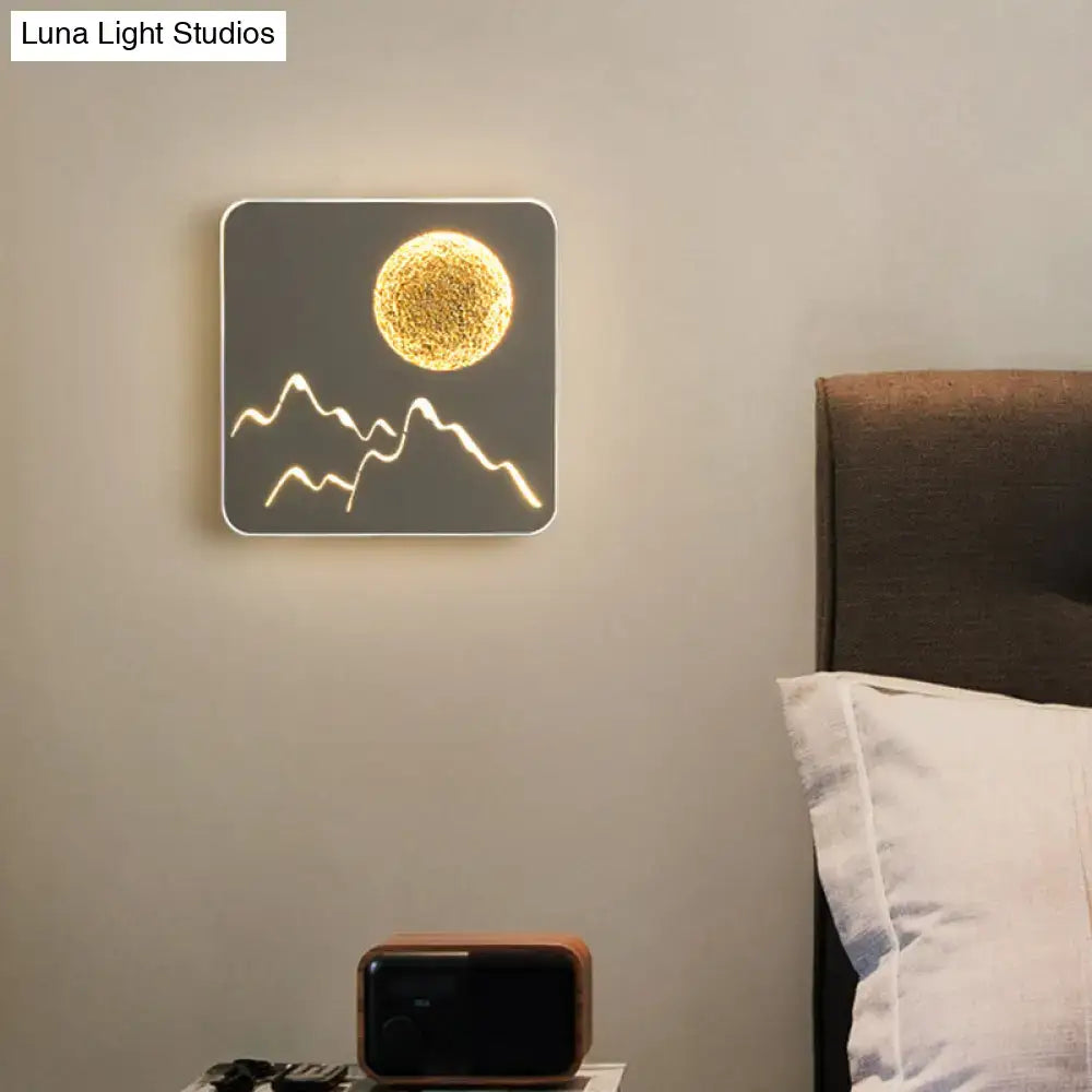 Square-shaped black white grey led wall light featuring a glowing golden sun and white mountain silhouette fixture height for bedroom