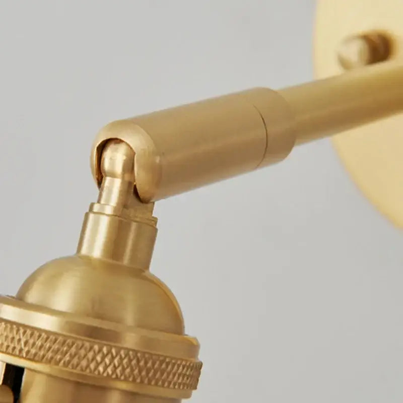 Brass-finished adjustable wall lights with clear glass and knurled base for decorbites clear glass bedroom sconce decor