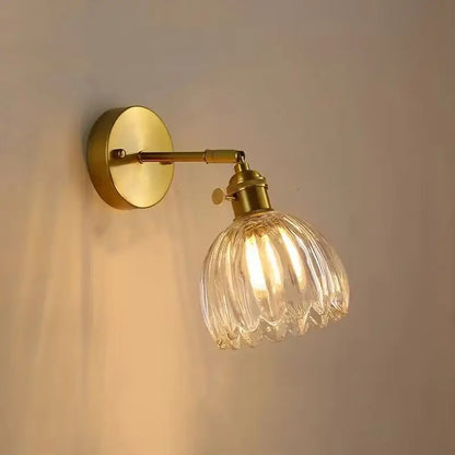 Nordic brass faceted wall light with clear ribbed glass shade for bedroom featuring decorbites clear glass design
