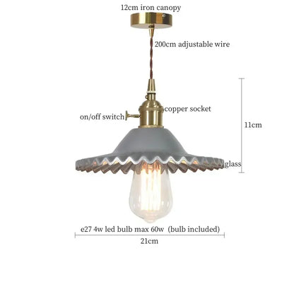 Gray scalloped glass flounce led pendant light with brass accents and visible Edison bulb for dining room use