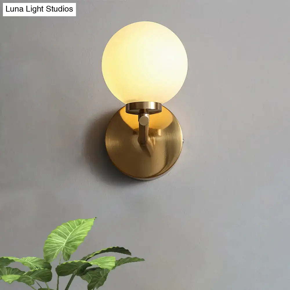 Nordic brass wall sconce light with gold-toned spherical design and frosted glass globe for bedroom lighting 110v-120v 220v-240v