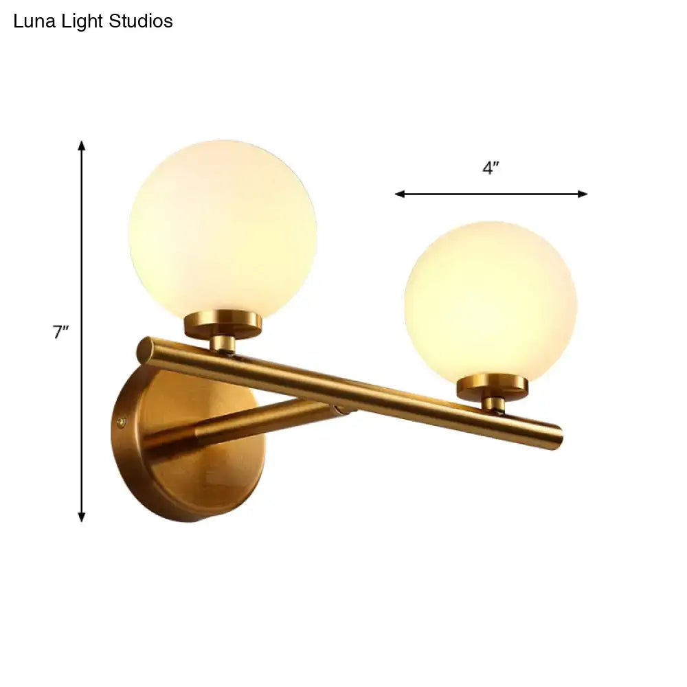 Gold-toned nordic brass wall sconce light with two frosted glass globe shades for bedroom lighting 110v-120v 220v-240v