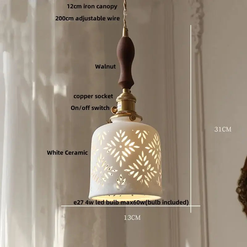 White ceramic pendant light with intricate floral cutouts, walnut-finished handle, and brass accents for decorbites brown wood led decor