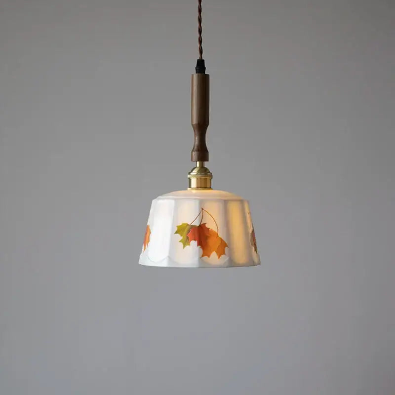 White ceramic pendant light with autumn leaf decals and a wooden handle for dining room brown wood led decorbites