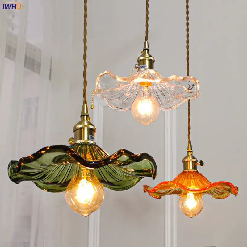 Three colorful glass copper led pendant lights with wavy leaf designs and brass fixtures for dining room use